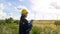 Woman engineer is wearing a protective helmet on her head, using tablet Analytics engineering data