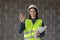 woman engineer in a white helmet and safety vest, the engineer on the construction site