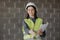 woman engineer in a white helmet and safety vest, the engineer on the construction site