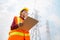 Woman Engineering working on High-voltage tower