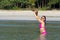 Woman enjoy bikini pink and hat on beach