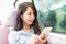 Woman enjoy music on cellphone inside train compartment