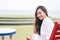 Woman enjoy sitting and relaxing on the bench by the sea