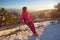 Woman enjoy sunlight at beautiful winter sunset