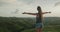 Woman enjoy sunset hills landscape, raises hands