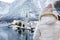 Woman enjoy winter scenic view of village of Hallstatt in the Austrian Alps