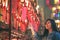 Woman enjoyed looking at red lamps and wishes in Chinese temple