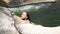 woman enjoying bathing in clear water in stony river. Beautiful woman relaxing while swimming in thermal source.