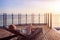 Woman enjoying beach vacation holidays, relaxing by luxury resort hotel swimming pool on deckchair lounger, looking at sunset.