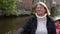 Woman enjoying a beautiful view when floating on the river channel by boat.