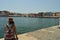 Woman Enjoying The Beautiful Views Of The Port Of Chania In Venetian Style. History Architecture Travel.