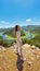 woman enjoying beauty of nature looking at mountain lake in Montenegro