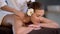 Woman enjoying body massage at spa club