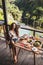 Woman enjoying breakfast, terrace with jungle view