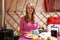 Woman Enjoying Breakfast Whilst Camping In Traditional Yurt