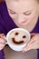 Woman enjoying cappuccino with a smile