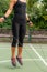 A woman enjoying a dynamic outdoor jump rope workout, promoting a healthy and active lifestyle