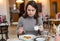 Woman enjoying espresso with apple strudel in coffee house