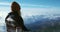 Woman enjoying landscape in mountains over clouds Travel Lifestyle concept