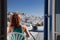 woman enjoying mykonos town view from terrace, Greece - summer holiday