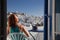 woman enjoying mykonos town view from terrace, Greece - summer holiday