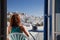 woman enjoying mykonos town view from terrace, Greece - summer holiday