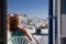 woman enjoying mykonos town view from terrace, Greece - summer holiday