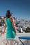 woman enjoying mykonos town view from terrace, Greece - summer holiday