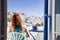 woman enjoying mykonos town view from terrace, Greece - summer holiday