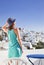 woman enjoying mykonos town view from terrace, Greece - summer holiday