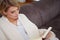 Woman enjoying reading a book at home lying on the