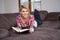 Woman enjoying reading a book at home lying on the