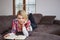 Woman enjoying reading a book at home lying on the