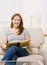 Woman enjoying reading a book in livingroom