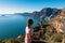 Woman enjoying the scenic view from hiking trail between Positano and Praiano at the Amalfi Coast, Campania, Italy, Europe