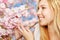 Woman enjoying scent of blooming cherry blossoms