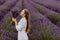 Woman Enjoying Smell of Lavender Flowers in Field