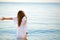 Woman enjoying summer freedom with open arms at the beach