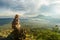 Woman enjoying sunrise from a top of mountain Batur, Bali, Indonesia