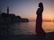Woman enjoying a sunset in a Rovinj, Croatia