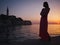 Woman enjoying a sunset in a Rovinj, Croatia