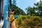 Woman enjoying train ride through Sri Lanka tea plantations