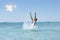 Woman enjoys cool sea water and splashing, in Greece