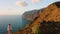 Woman enjoys nature landscape in hike to mountains. Aerial cliff peaks. Tenerife, Canary, Spain. Trevelers dream. Hiking