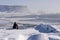 Woman enjoys view o three pinnacles of Vik, Iceland