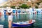 Woman enjoys the view to the fishing village of Klima, Milos, Cyclades, Greece