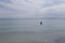 A woman enter to bath in the sea in El Arenal Beach