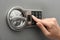 Woman entering code on keypad of safe, closeup