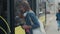 Woman entering the door of the modern tram at the station.