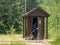 Woman entering restroom in forest